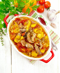 Ragout of meat and vegetables in brazier on light board top