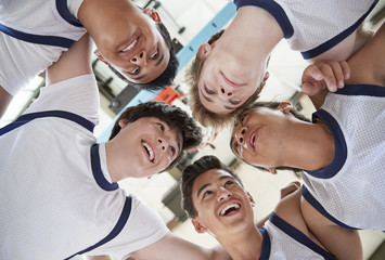Low Angle View Of Male High School Basketball Players Having Team Talk