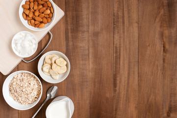 Wooden background with ingredients for healthy breakfast