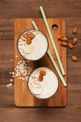 Two portion of banana smoothies with oat flakes
