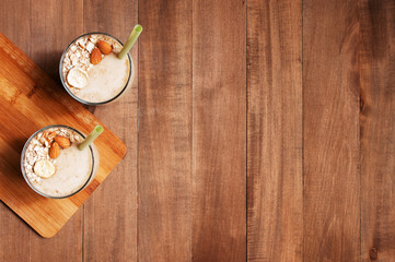 Wooden background with fresh banana smoothies