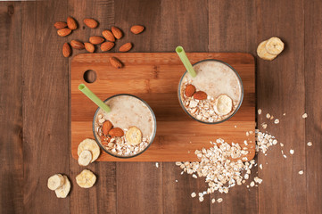 Two portion of banana smoothies with oat flakes