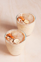 Fresh banana smoothies with oat decorated with almond