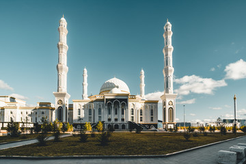 Fototapeta na wymiar Outside view Mosque Hazrat Sultan in Astana capital of Kazakhstan on a clear day with sun blue sky