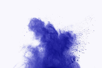 Abstract blue powder explosion on white background. abstract blue dust splatted on white background, Freeze motion of blue powder exploding.