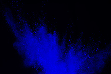 Abstract blue dust explosion on black background. abstract blue powder splatted on black...