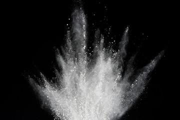 Explosion of white powder isolated on black background. Abstract of powder or clouds splatted.