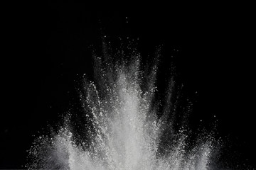 Explosion of white powder isolated on black background. Abstract of powder or clouds splatted.