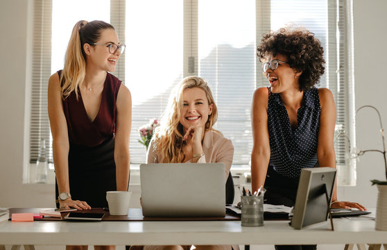 Group of three diverse women in office