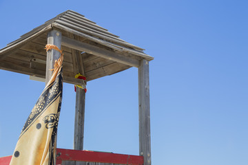 close-up with lifeguard tower detail with sky in the background