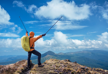 Hiker enjoying the trip in the top of mountain.