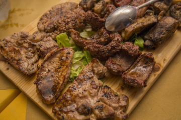 image of various types of grilled meat presented on a wooden chopping board