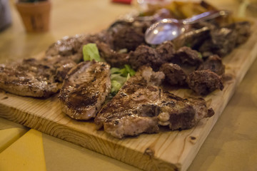 image of various types of grilled meat presented on a wooden chopping board