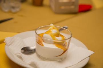 closeup of dessert with ice cream and creme caramel in glass jar