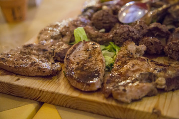 image of various types of grilled meat presented on a wooden chopping board