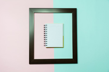 Top view of notebook in middle of frame on colorful background and copy space for insert text.