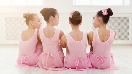 Little ballerinas talking in ballet studio