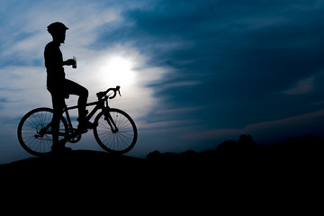 Silhouette of the cyclist riding a road bike at sunset.Mountain bicycle and man.Life style outdoor