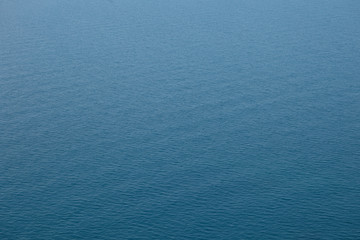 Endless sea with smooth turquoise surface. Perfect vacations at seaside. Horizontal shot of limitless blue ocean on sunny summer day with copy space for your text, information or promotional content