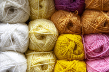 Store shelf with color yarn for knitting with needles, crochet hook.