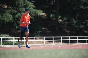 Disabled man athlete training with leg prosthesis