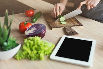 Happy woman preparing healthy food in the home kitchen