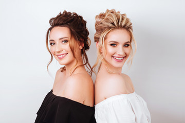 studio portrait of two young beautiful women