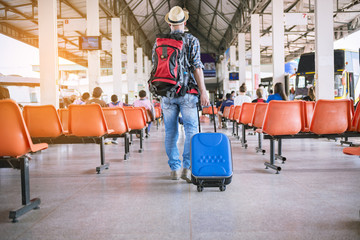 backpack young man traveler holding map in the bus station. Travel concept