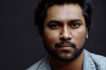 Fototapeta premium close up cropped photo of hindoo guy with pleasant appearance looking at the camera. cropped photo. isolated black background