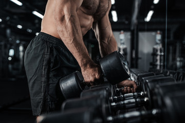 Fototapeta na wymiar Muscular man working out in gym