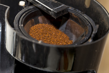 close-up of ground coffee inside filter during preparation