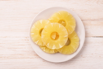 Top view of canned pineapple slices on plate
