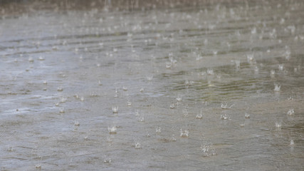 Heavy rain on the city pavement