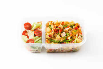 Healthy meal prep container with pasta salad with turkey and vegetables isolated on white background