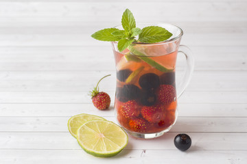 Cocktail with black currant, strawberry, mint and lime. Cooling summer drink.