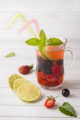 Cocktail with black currant, strawberry, mint and lime. Cooling summer drink.