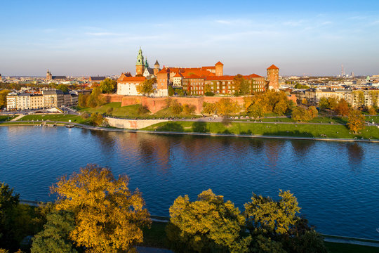 Panorama of Cracow, Poland, with royal Wawel castle, cathedral and Vistula river in autumn. Aerial view at sunset.