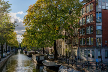 Amsterdam canal view at sunset with boat houses