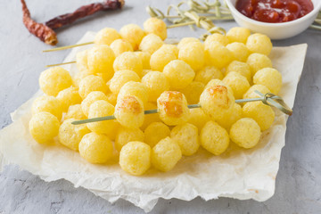 Cheese corn balls with spicy tomato sauce