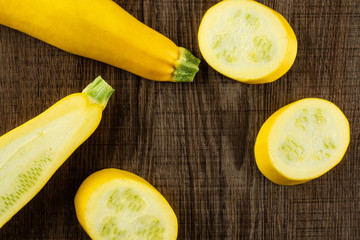 Fresh Raw yellow zucchini on brown wood