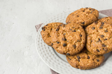 Homemade cookies with chocolate in a plate on a grey table. Chocolate chip cookie shot