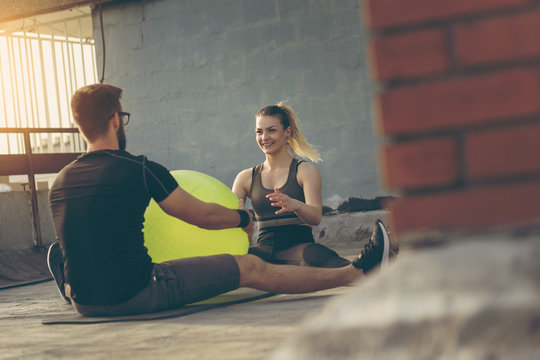 Couple exercising with a pilates ball