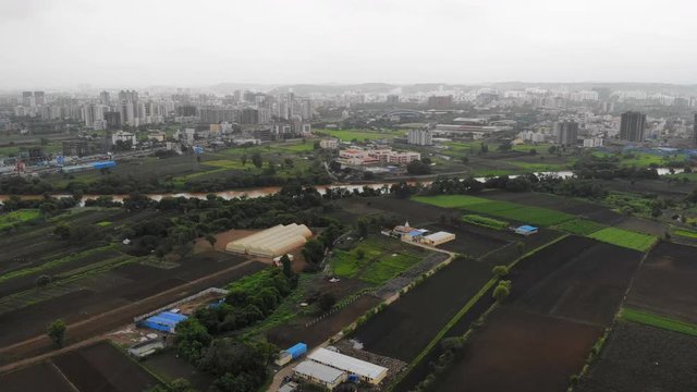 Aerial panoramic view of cityscape of modern industrial city of Pune during monsoon season - Maharashtra, landscape panorama of India, Asia from above