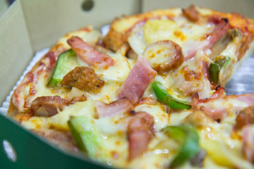 Pizza in the green cardboard box.