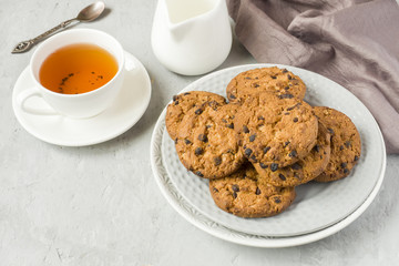 Homemade cookies with chocolate in a plate on a grey table. Chocolate chip cookie shot