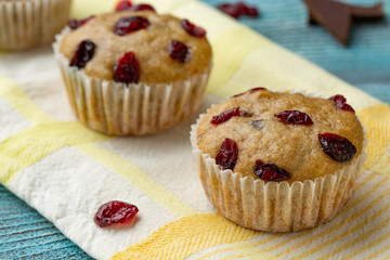 Cupcakes with cherries are located in a row.