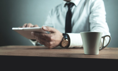 Businessman using white digital tablet.