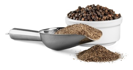 milled black pepper isolated on white background