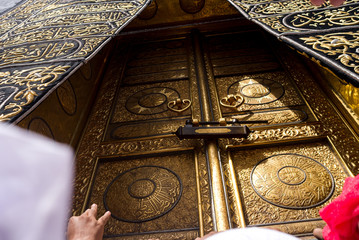 MECCA, SAUDI ARABIA - MAY 01 2018: The golden doors of the Holy Kaaba closeup, covered with Kiswah. Massive lock on the doors. Entrance to the Kaaba in Masjid al Haram