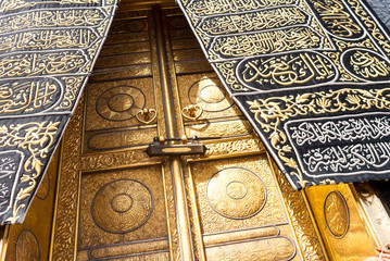 MECCA, SAUDI ARABIA - MAY 01 2018: The golden doors of the Holy Kaaba closeup, covered with Kiswah. Massive lock on the doors. Entrance to the Kaaba in Masjid al Haram